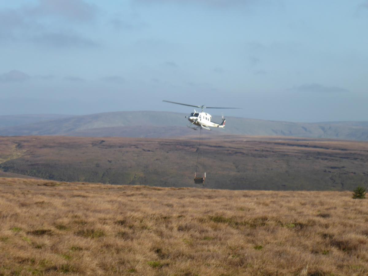 Helicopter lifting materials for peatland restoration at Langden Head.