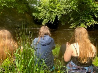 Students sat by the pond Students sat by the pond