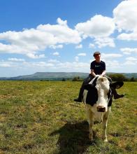Riding bareback on Betty the cow with Pendle Hill in the background © Joanne Collinge