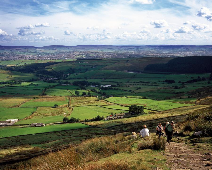 Landscape view from Pendle Hill with walkers climbing the hill