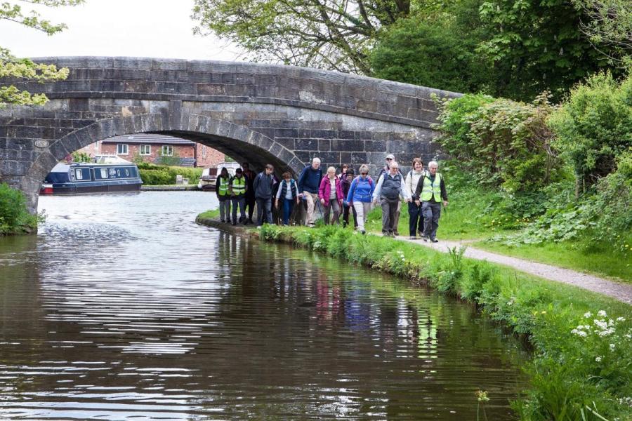 Walking group by a canal