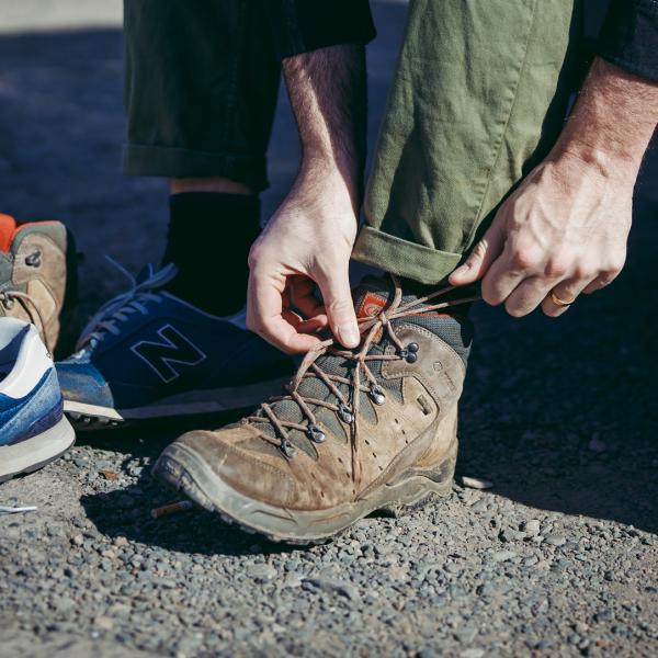 Person tying a walking boot