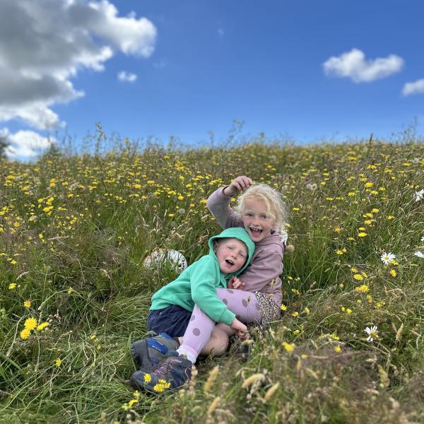 Children in a hay meadow at Meadow Day