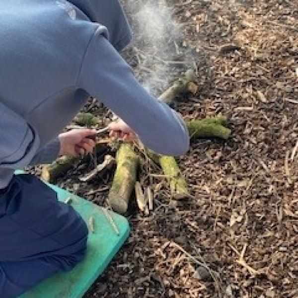 The Gathering Fields - child lighting a fire