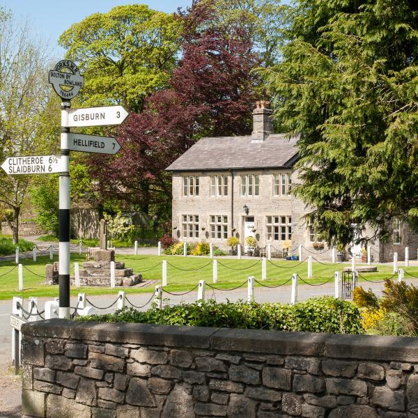 heritage road sign with buildings in the background