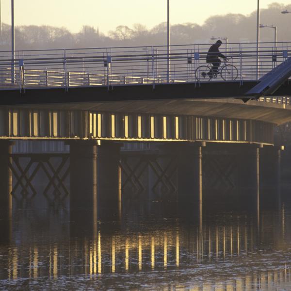 cyclist on bridge crossing rive lune